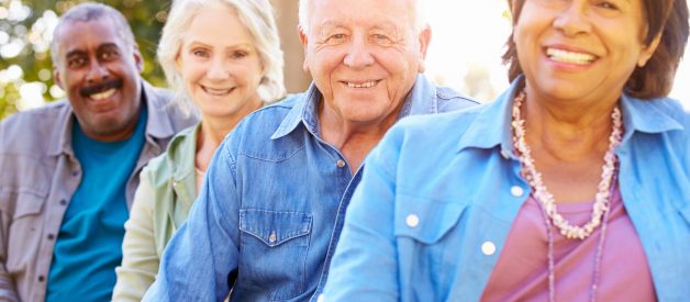 Outdoor Group Portrait Of Senior Friends Smiling To Camera